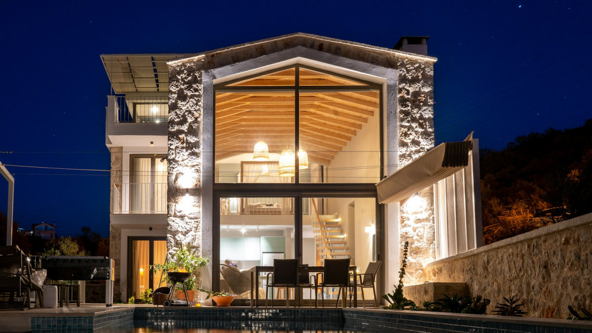 Une villa et sa piscine éclairée, la nuit
